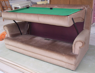 Illustration for article titled This Couch Turns Into a Snooker Table